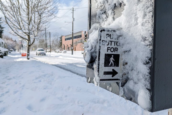 Snow and ice covers a crossing signal in the Grant Park neighborhood of Portland, Ore., Thursday Feb. 23, 2023. Winter storms sowed more chaos across the U.S. on Thursday, shutting down much of Portland after the city experienced its second snowiest day in history and paralyzing travel from parts of the Pacific Coast all the way to the northern Plains. (AP Photo/Drew Callister)