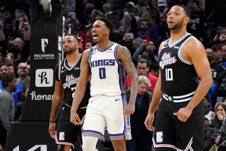Sacramento Kings guard Malik Monk, center, celebrates as time runs out in double overtime. Monk scored a career-high 45 points in Sacramento's win on Friday.