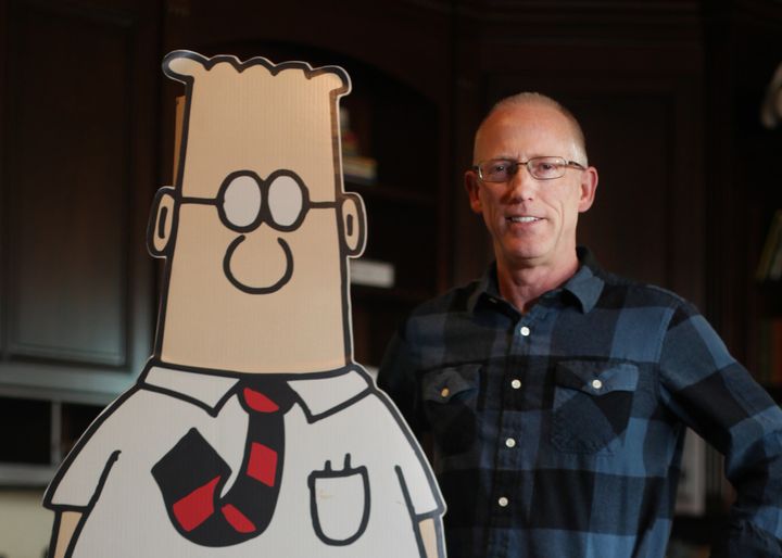 Scott Adams stands for his creation.