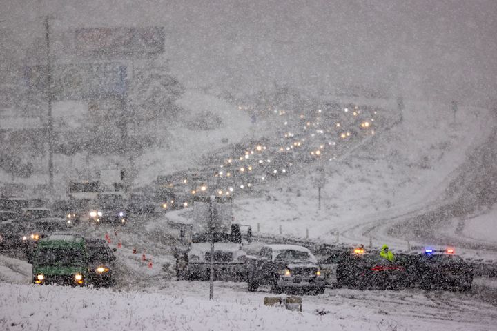 Traffic backs up on the State Route 14 freeway due to snow near Acton, California. 