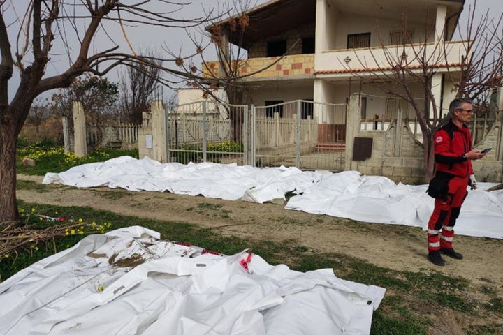 Bags containing the bodies of deceased migrants are seen after their boat sank. More than 30 migrants, including a baby, died after their overloaded boat sank early Sunday.