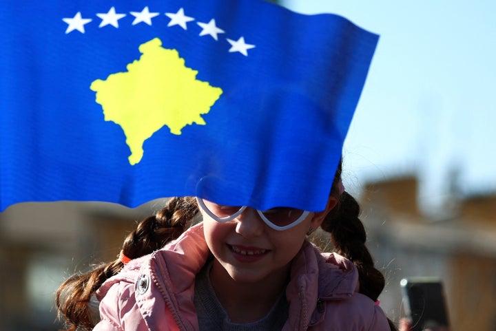 A child attends a parade during celebrations of the 15th anniversary of Kosovo 