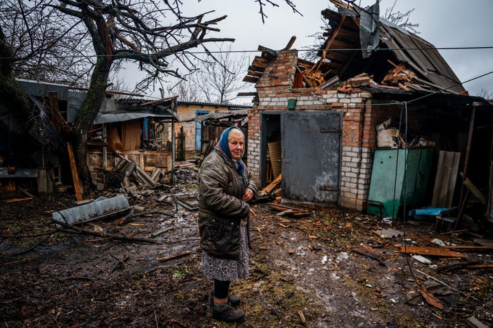 <strong>An elderly woman stands in her backyard after shelling in Chasiv Yar, near Bakhmut.</strong>