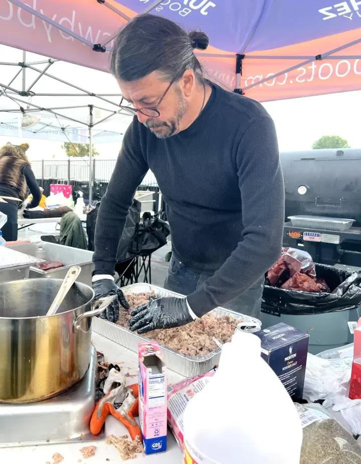 Dave Grohl prepares meat at Hope the Mission's Trebek Center in Northridge, California, in February 2023 during the winter storms.