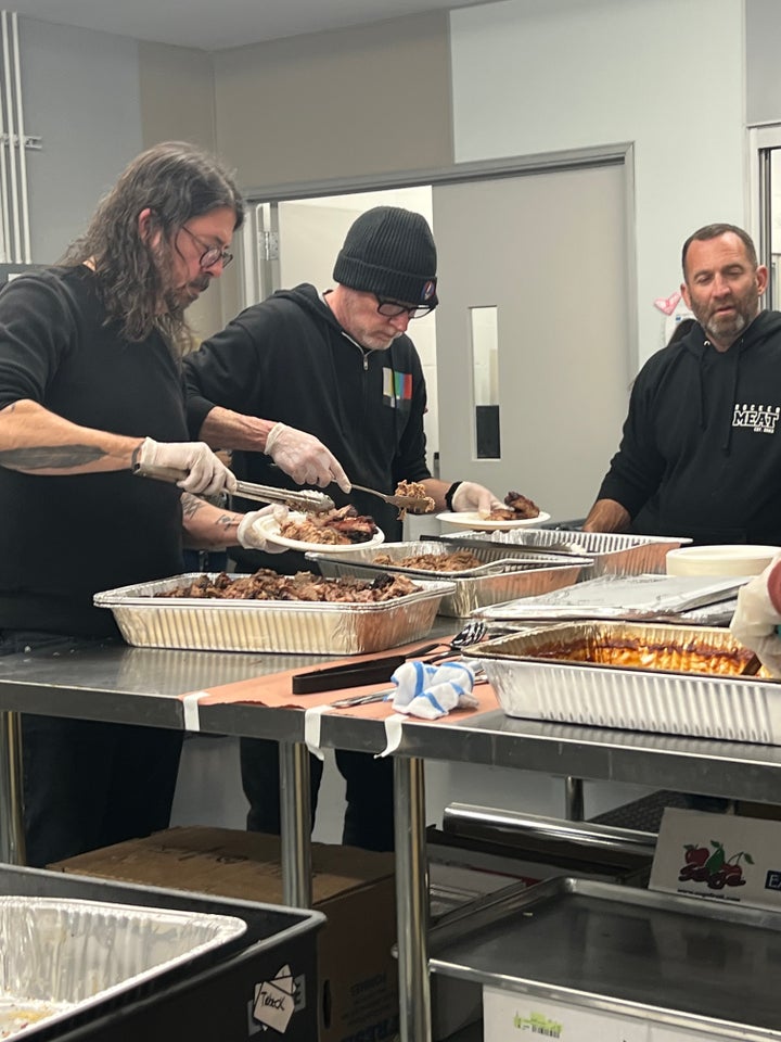 Grohl in the kitchen with the meats he spent hours preparing and cooking. 