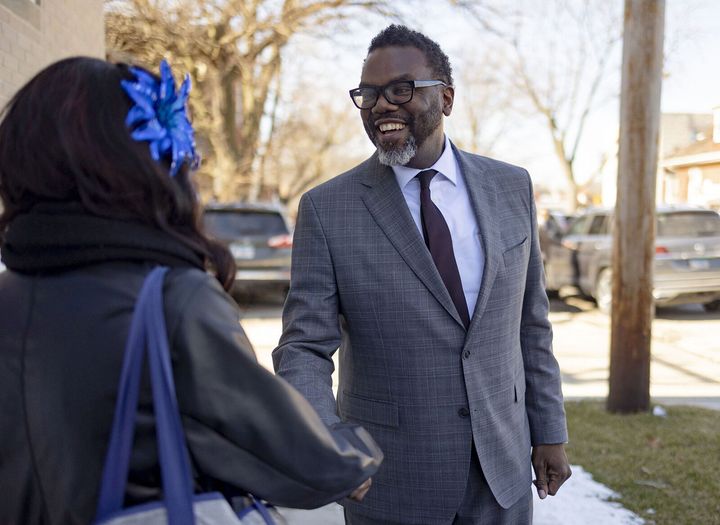 Brandon Johnson greets a voter after a church service on Sunday. His second-place finish sets up a stark ideological and policy battle with Vallas in the runoff.