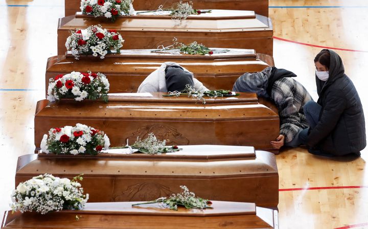 Μετανάστες θρηνούν δίπλα στα φέρετρα των συγγενών τους που πέθαναν σε ναυάγιο, στον Κρότονα της Ιταλίας, 1 Μαρτίου 2023.