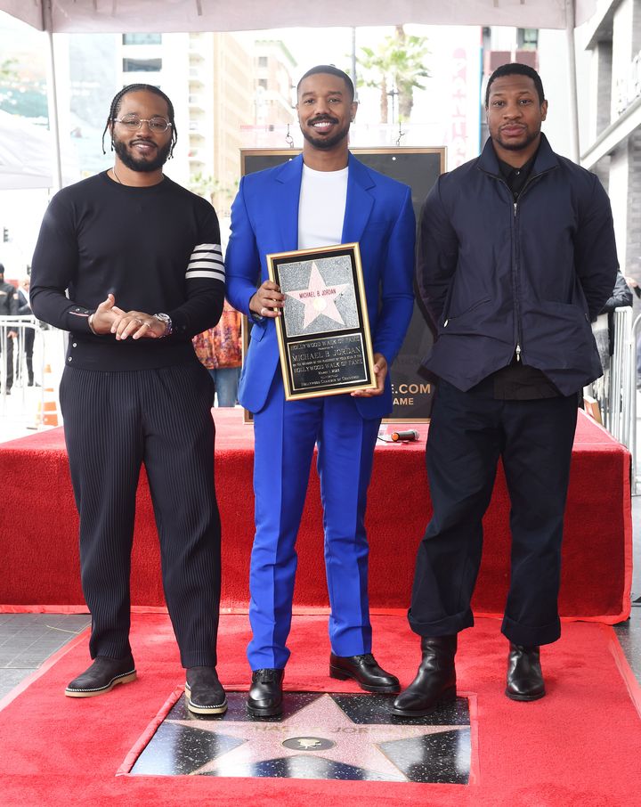 Ryan Coogler (left) and Jonathan Majors (right) stand together as Michael B. Jordan (center) smiles at a Hollywood Walk of Fame ceremony on Wednesday in Los Angeles.