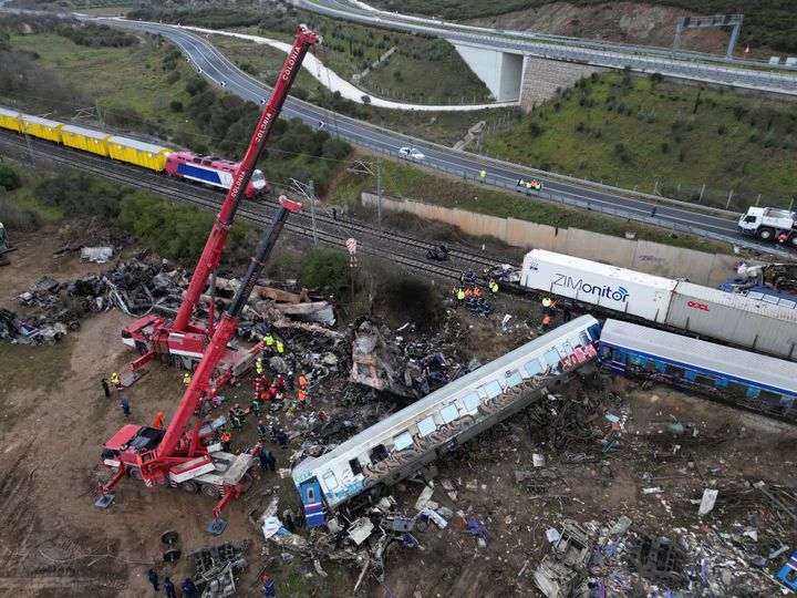Firefighters and rescuers supported by two cranes, search through the wreckage after a trains collision in Tempe, about 376 kilometres (235 miles) north of Athens, near Larissa city, Greece, on March 2, 2023.
