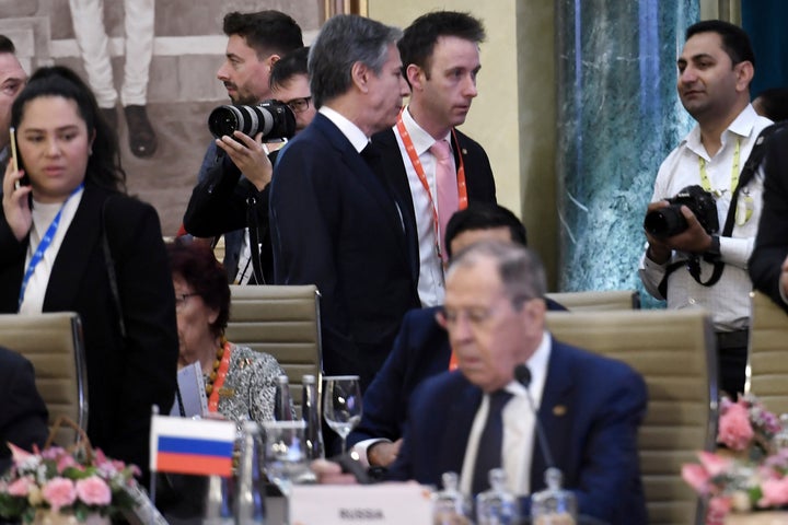 U.S. Secretary of State Antony Blinken, top center, walks past Russian Foreign Minister Sergey Lavrov during the G20 foreign ministers' meeting in New Delhi on March 2, 2023.