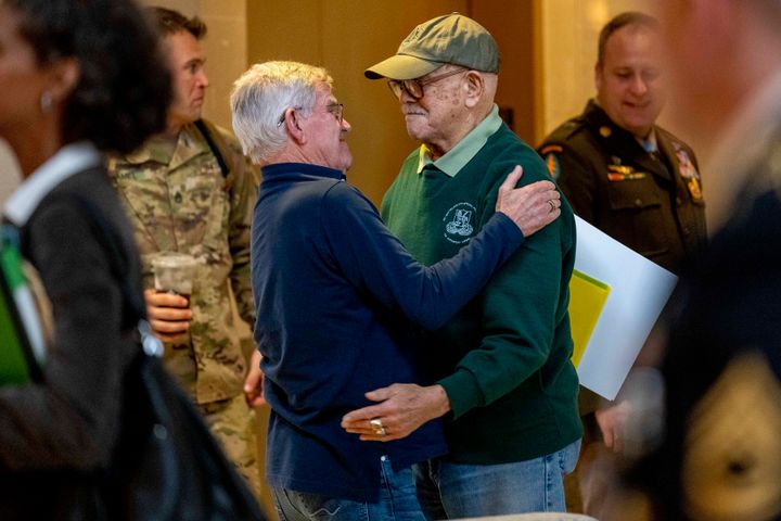 Retired Army Col. Paris Davis, an Ohio native, who is set to receive the Medal of Honor for his service in the Vietnam War, hugs his friend Jim Moriarty before sitting down for an interview with the Associated Press at a hotel in Arlington, Va., on March 2, 2023. 