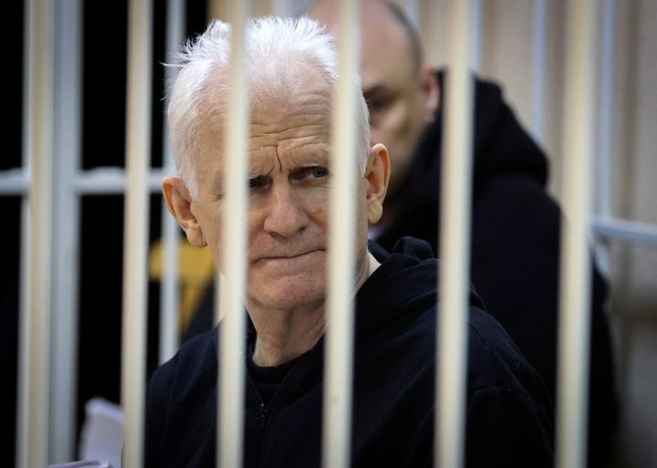 Ales Bialiatski, the head of Belarusian Vyasna rights group, sits in a defendants' cage during a court session in Minsk, Belarus, on Jan. 5, 2023.