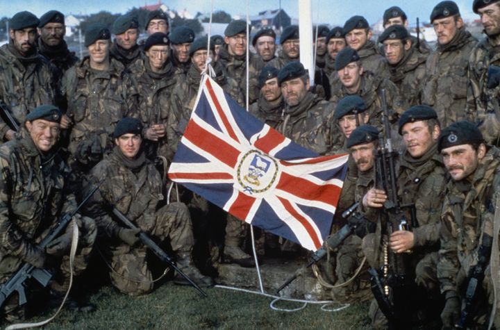 The Royal Marine garrison of the Falkland Islands evicted by the Argentine invaders, with the Falkland Islands flag after the Argentine surrender, June 1982