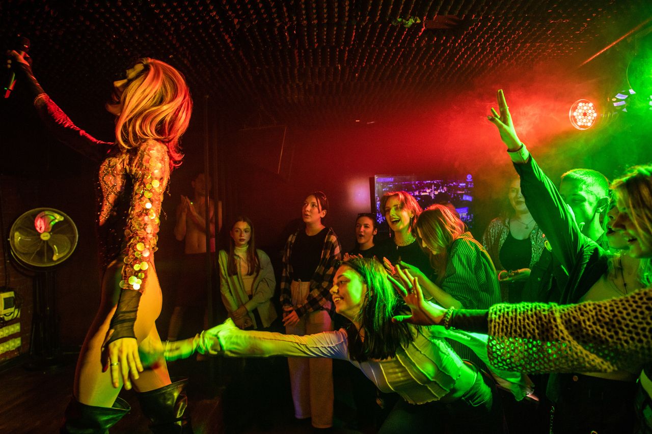 Members of the audience reach for drag queen Adele during a drag show in Kyiv, Ukraine.