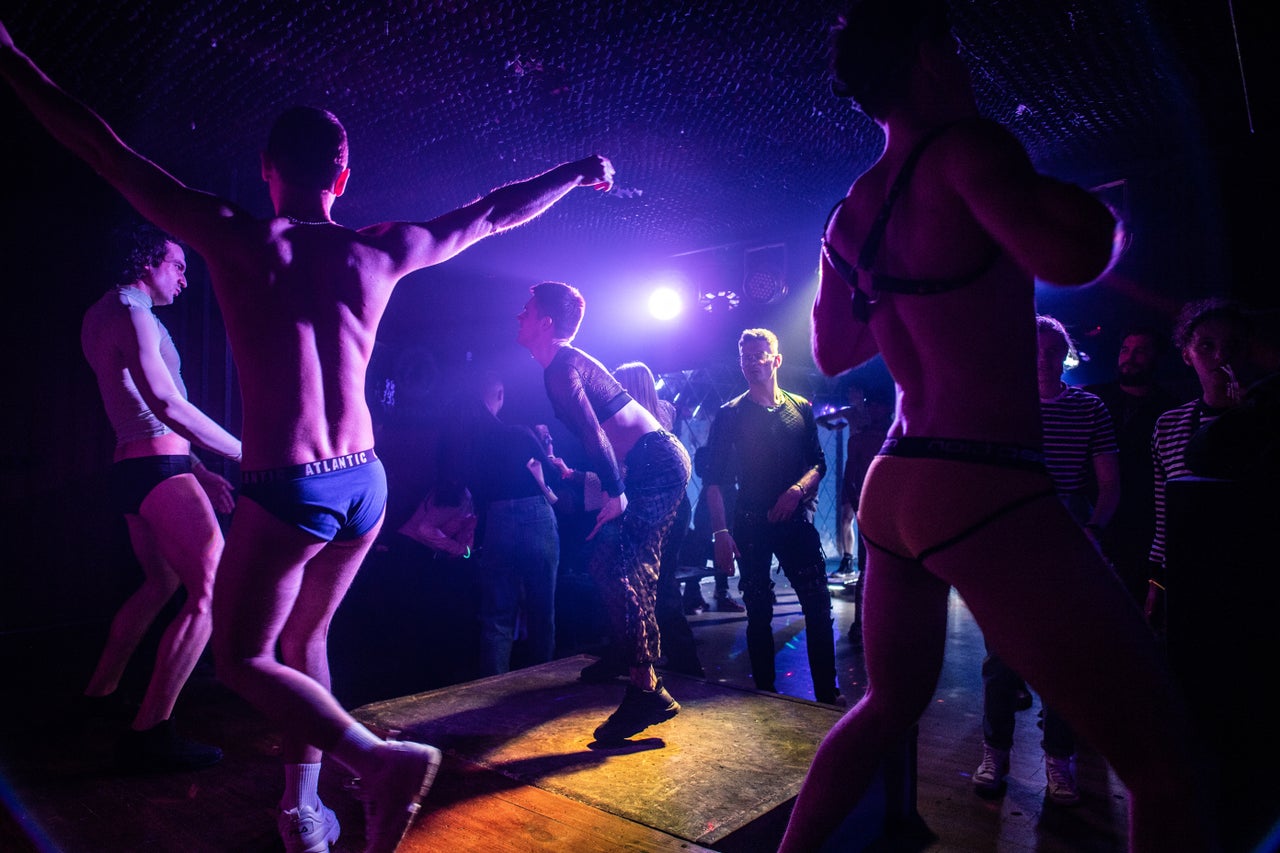 The Go-Go GIANNI Boys perform on stage during a drag show at G-Versace Club in Kyiv.