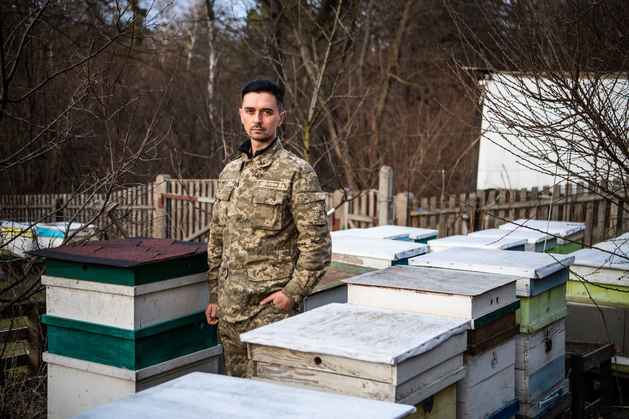 Arthur Ozerov in his military uniform at his home outside of Kyiv, where he keeps bees and has a garden.