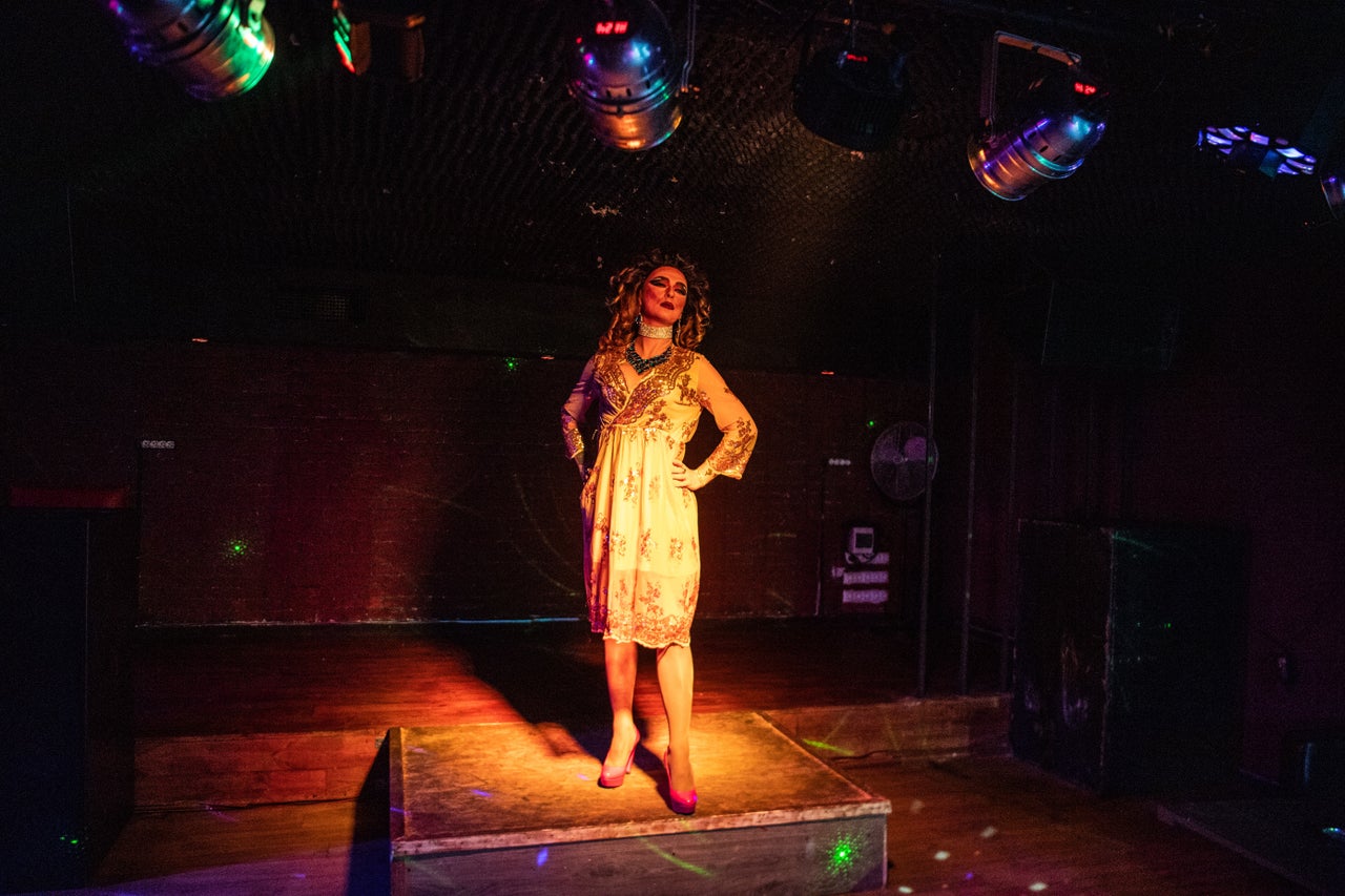 Aura poses on stage before a drag show at G-Versace Club.