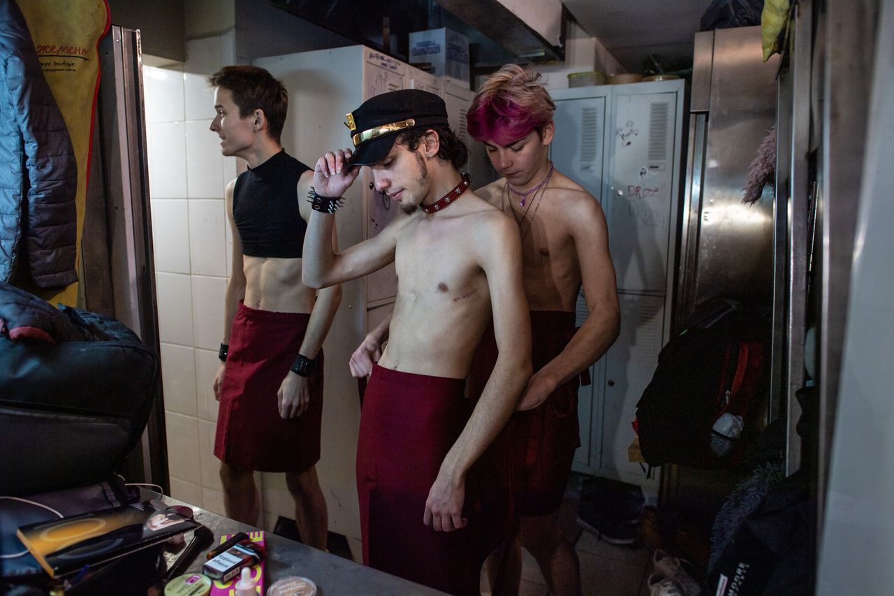 Members of Go-Go GIANNI Boys get ready backstage.
