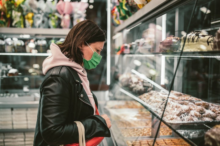 Middle age woman choosing a dessert in a shop