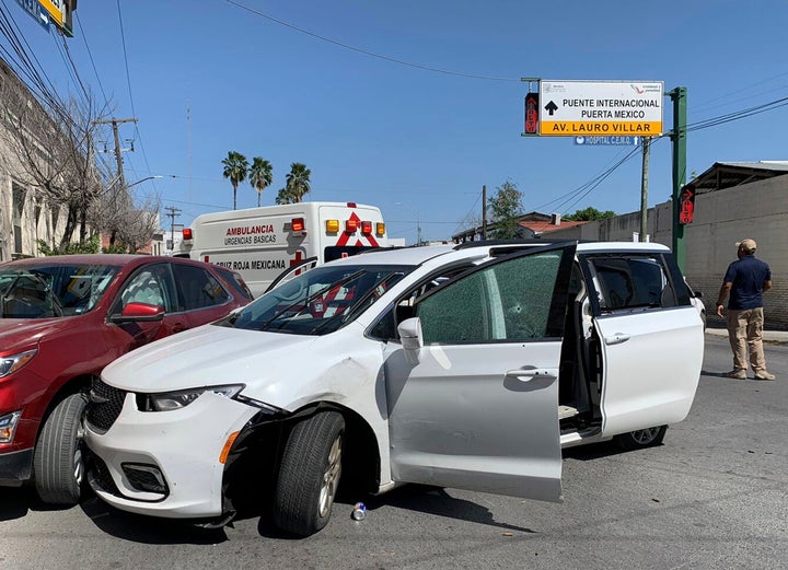 A member of the Mexican security forces stands next to a white minivan with North Carolina plates and several bullet holes, at the crime scene where gunmen kidnapped four U.S. citizens who crossed into Mexico from Texas, Friday, March 3, 2023. Mexican President Andres Manuel Lopez Obrador said the four Americans were going to buy medicine and were caught in the crossfire between two armed groups after they had entered Matamoros, across from Brownsville, Texas, on Friday. (AP Photo)