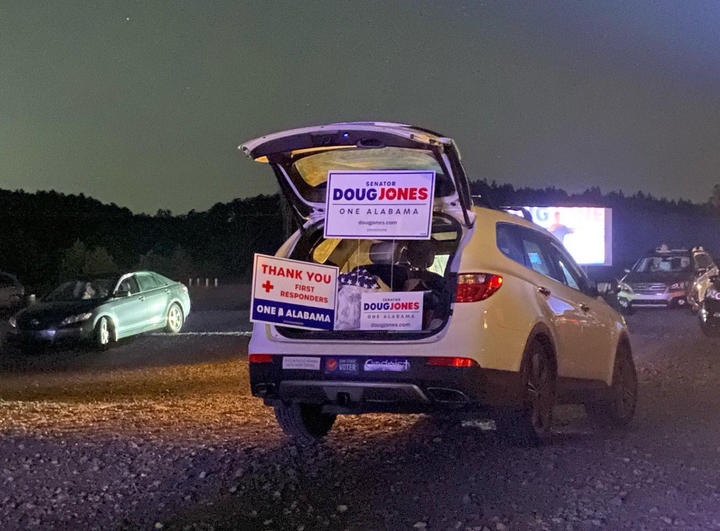 Yard signs at one of Sen. Doug Jones’ COVID-19 drive-in rallies.