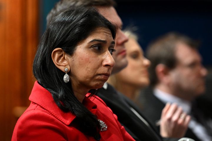 Suella Braverman listens to Rishi Sunak during a press conference after the government unveiled plans for new laws to curb Channel crossings.