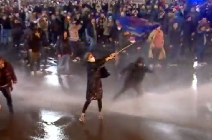 A woman in Georgia protested new legislation by waving an EU flag
