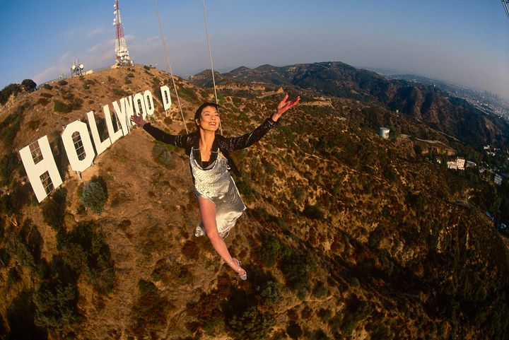 Actress Michelle Yeoh in mid-air over the famous Hollywood sign in November 1998 in Los Angeles, California.