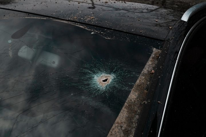 A scharpnel hole covers the windshield of a car near the area where a rocket attack took place, in Kyiv, Ukraine, on March 9, 2023.