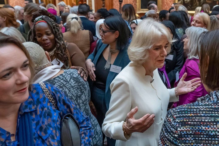 Queen Consort Camilla speaks to guests near Ngozi Fulani (back left), chief executive of the London-based Sistah Space group, during a reception to raise awareness of violence against women and girls at Buckingham Palace on November 29, 2022.