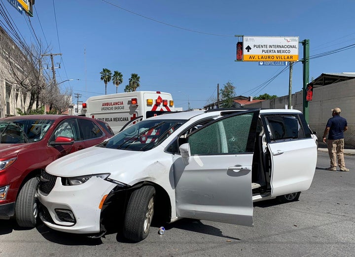 A member of the Mexican security forces stands next to a white minivan with North Carolina plates and several bullet holes, at the crime scene where gunmen kidnapped four U.S. citizens who crossed into Mexico from Texas, on March 3, 2023.