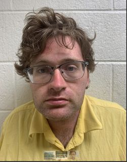 Charles Sutherland, 31, was found to possess child pornography after his arrest for spray-painting the word "Groomer" on two libraries, police say.