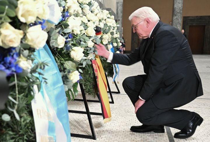German President Frank-Walter Steinmeier kneels at the White Rose Memorial in Bavaria on Feb. 6, 2023.