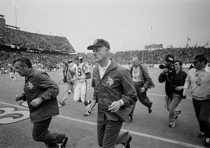 FILE - Minnesota Vikings head coach Bud Grant, foreground, and his staff run off the field at Rice Stadium in Houston following the Jan. 14, 1974, NFL football Super Bowl game against the Miami Dolphins. Grant, the stoic and demanding Hall of Fame coach who took the Minnesota Vikings and their mighty Purple People Eaters defense to four Super Bowls in eight years and lost all of them, has died. He was 95. (AP Photo/File)