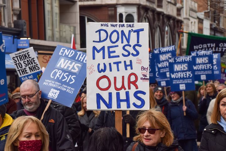  A protester holds a placard which states 'Don't mess with our NHS' during the demonstration in Tottenham Court Road. 