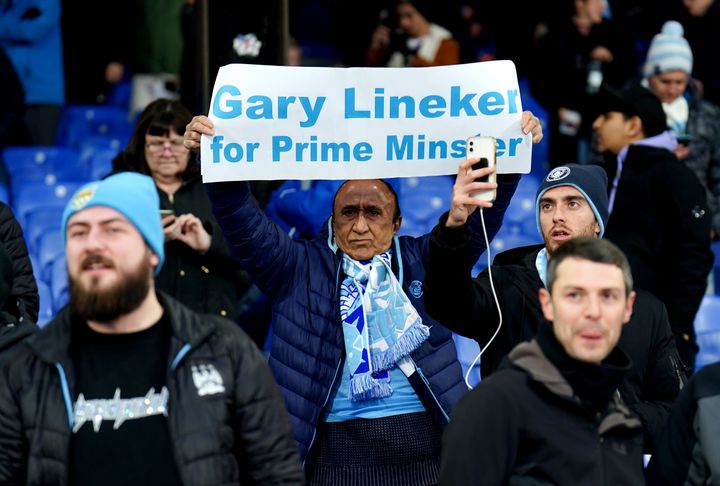 A Manchester City fan holds up a sign in support of Gary Lineker.