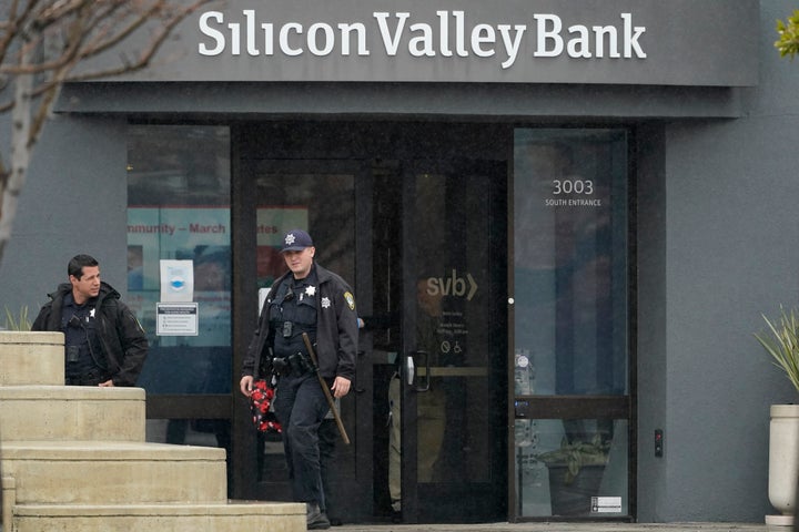 Santa Clara Police officers exit Silicon Valley Bank in Santa Clara, Calif., on March 10, 2023.