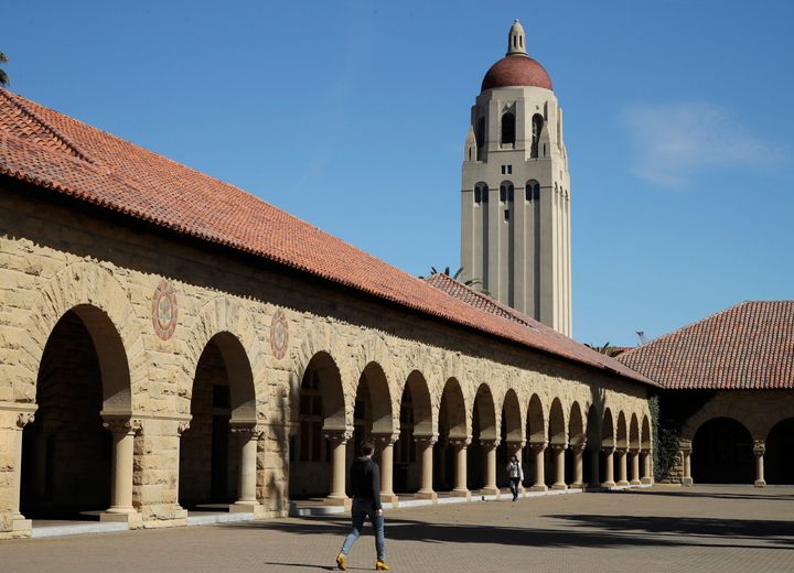 People walk on the Stanford University campus beneath Hoover Tower in Stanford, California, on March 14, 2019.
