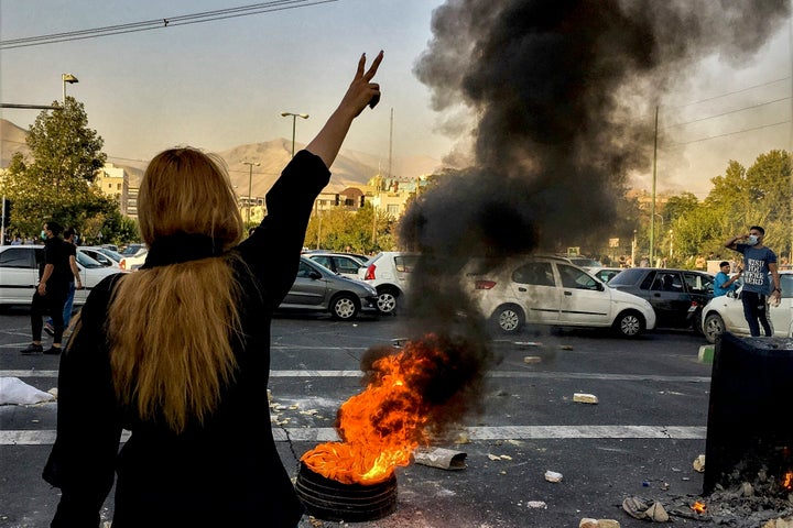 In this photo taken by an individual not employed by the Associated Press and obtained by the AP outside Iran, Iranians protests the death of 22-year-old Mahsa Amini after she was detained by the morality police, in Tehran, Oct. 1, 2022.