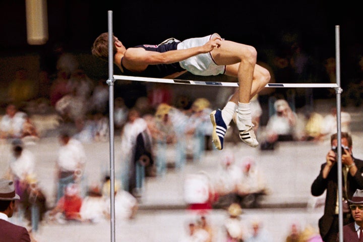 FILE - In this 1968 file photo, Dick Fosbury, of the United States, clears the bar in the high jump competition at the 1968 Mexico City Olympics. Fosbury is celebrated for the "Fosbury Flop," which revolutionized high-jumping. As he clears the bar he twists his body so that he goes over the bar head first which his back to the bar. (AP Photo/File)