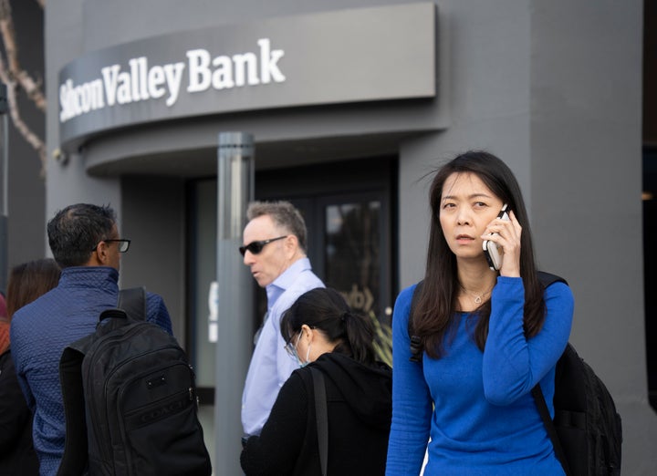 People queue up outside the headquarters of Silicon Valley Bank to withdraw their funds on March 13 in Santa Clara, California. 