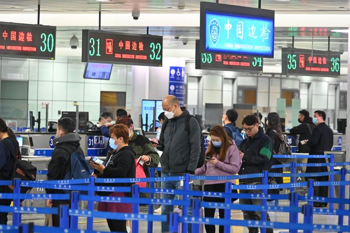 Travellers queue up to go through passport control at Shanghai Pudong International Airport on March 12, 2023 in Shanghai, China. The number of cross-border tourists at Shanghai Pudong International Airport has steadily increased since China optimized its epidemic prevention and control measures. 