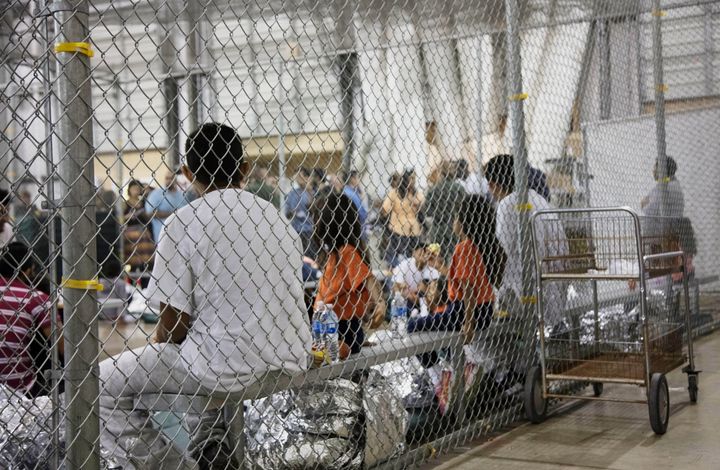 People who've been taken into custody related to cases of illegal entry into the United States, sit in one of the cages at a facility in McAllen, Texas, on June 17, 2018.