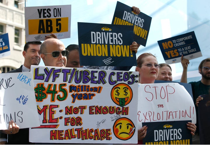 In this Aug. 28, 2019, file photo, dozens of supporters of a measure to limit when companies can label workers as independent contractors rally at the Capitol in Sacramento, Calif.