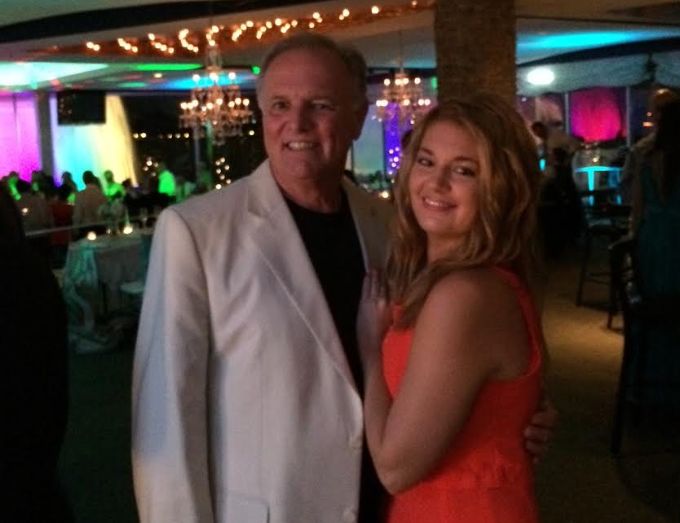 The author and her father at a wedding in summer 2014, three months after he was diagnosed with colon cancer. "This is one of the last photos taken of just the two of us together," she writes.