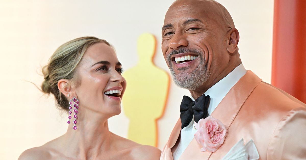 Emily Blunt Cheekily Chimes In During The Rock's Oscars Red Carpet