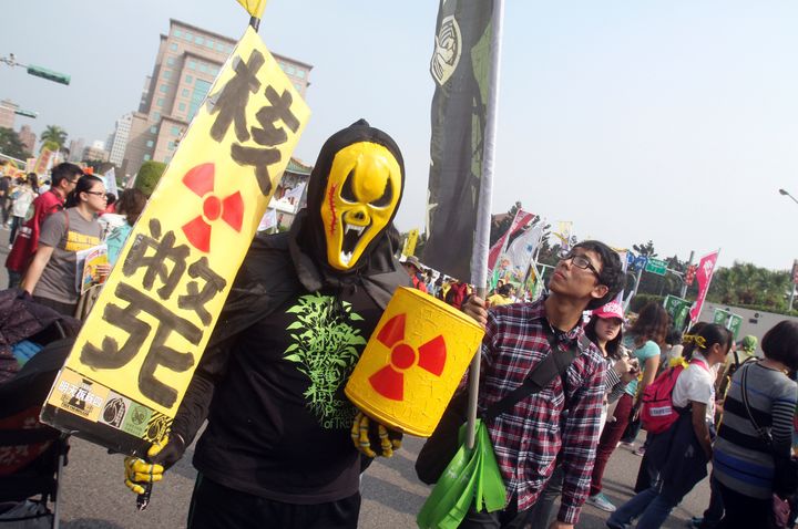 A protester holds a slogan reading "Nuke Death" during an anti-nuclear demonstration in Taipei, Taiwan, on March 14, 2015.