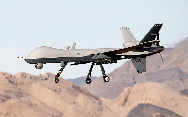 An MQ-9 Reaper remotely piloted aircraft flies by during a training mission at Creech Air Force Base on November 17, 2015 in Indian Springs, Nevada. (Photo by Isaac Brekken/Getty Images)