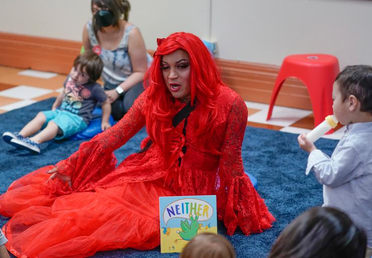 A drag queen who goes by the name Flame reads stories to children and their caretakers during a Drag Time Story Hour last summer at a New York public library.