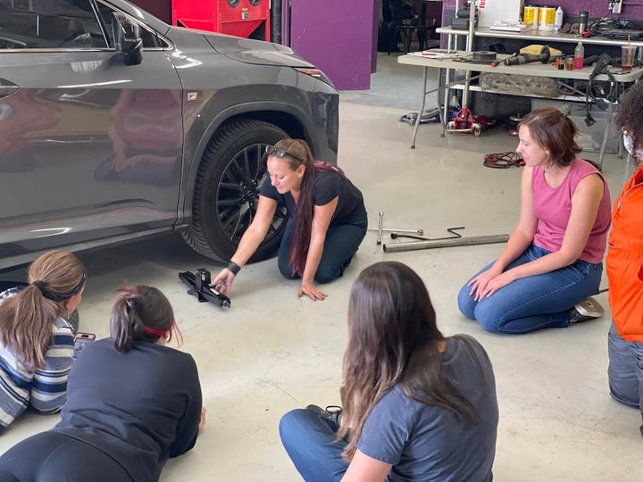 Bogi, a master technician teaching how to change a tire. 